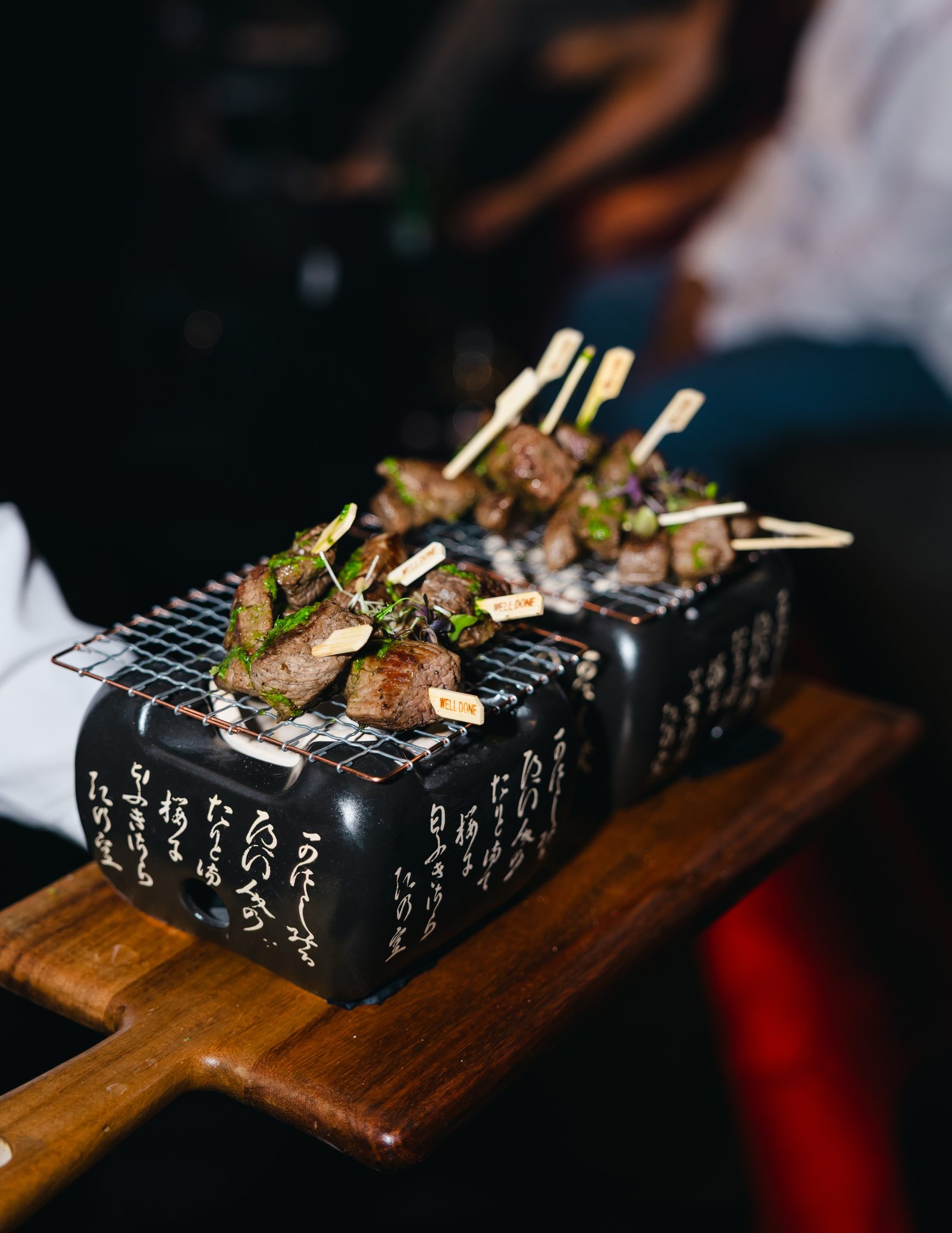 Anticucho skewers served over a small tabletop grill