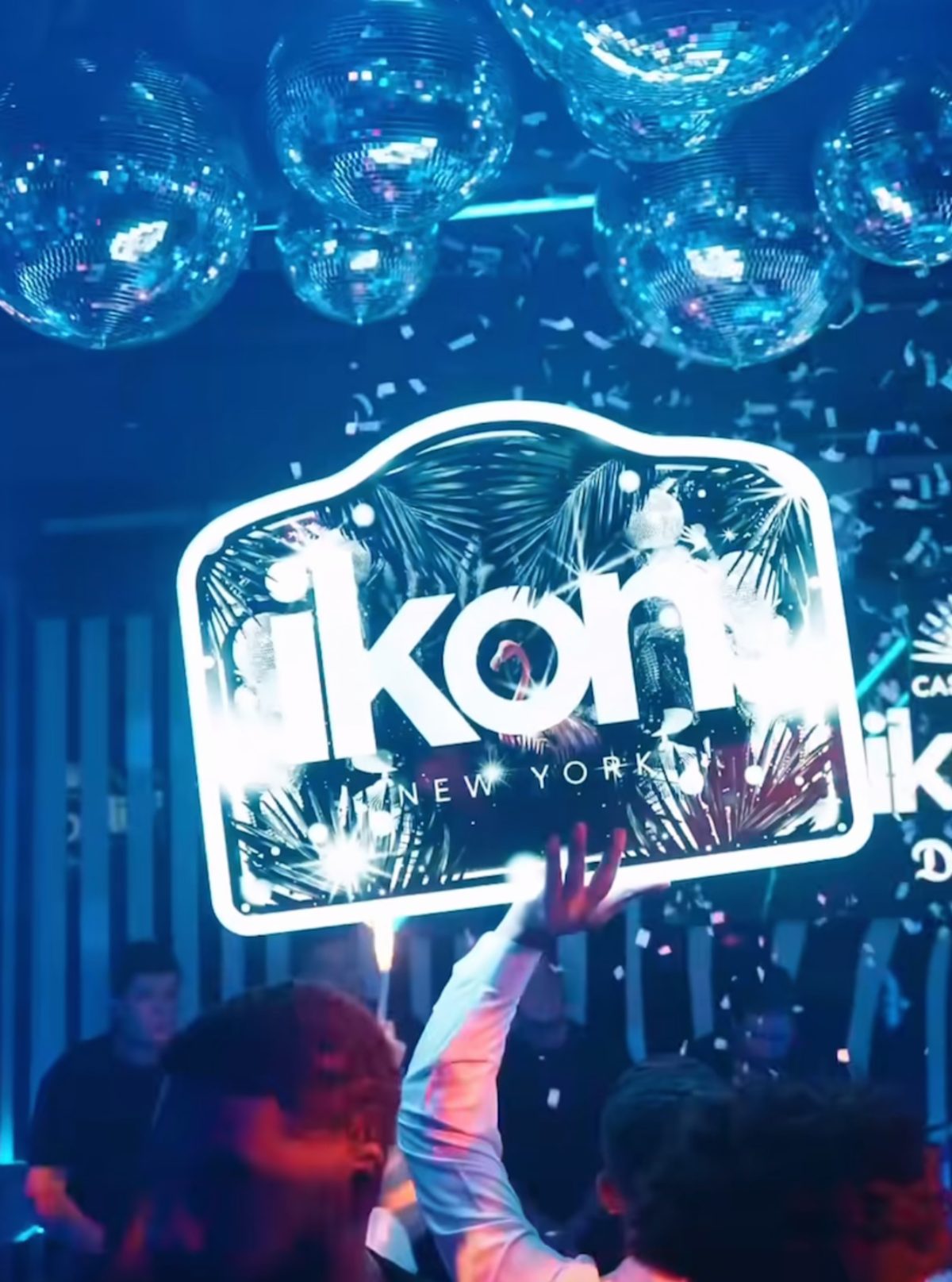 Guests holding the lit IKON sign during Sunday brunch