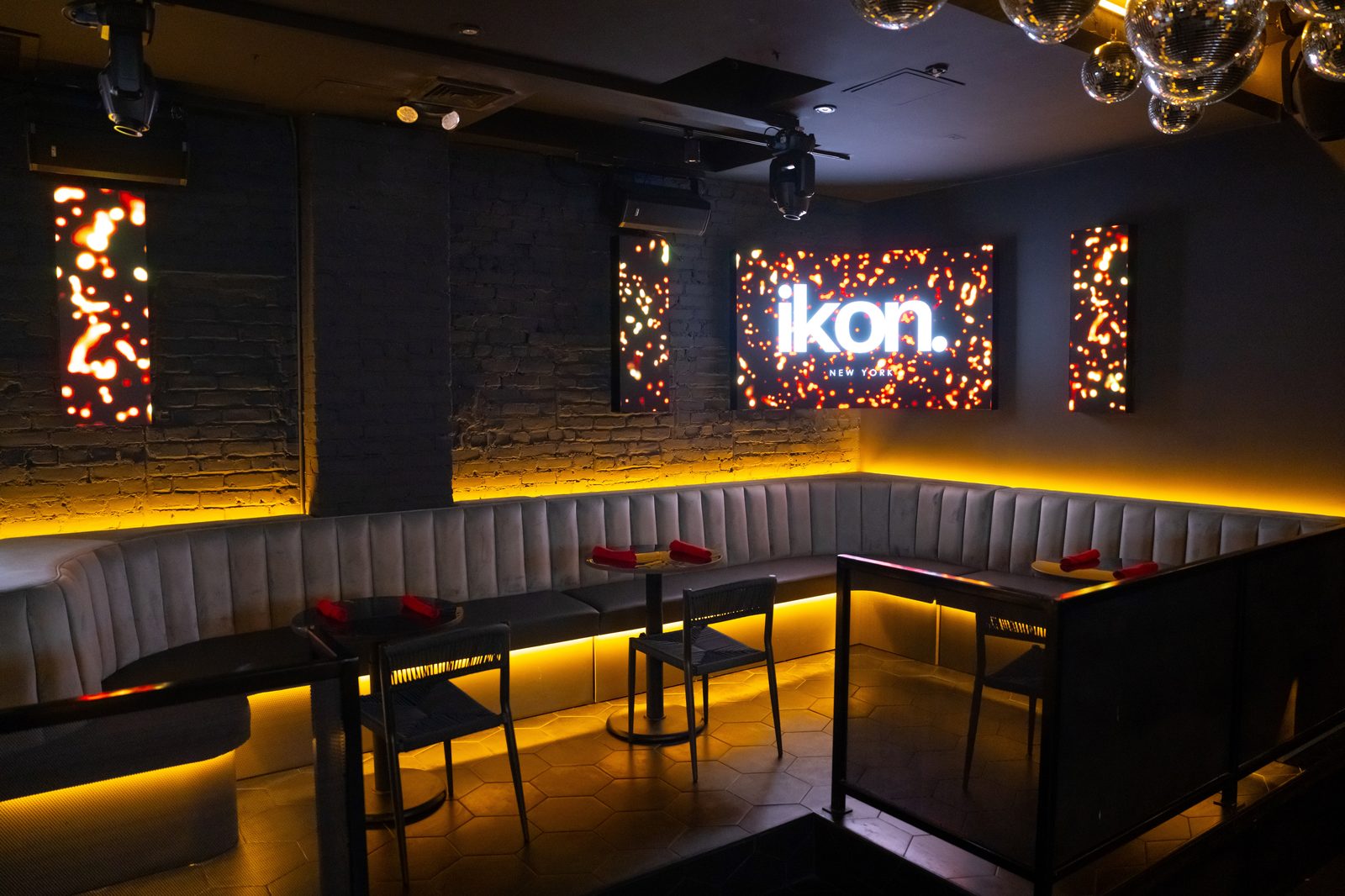Banquettes and the lit logo wall in the IKON dining room