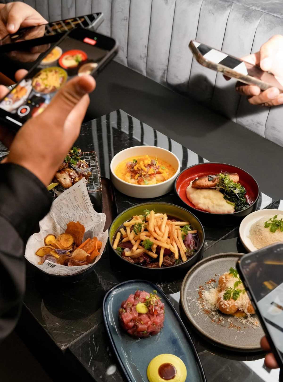 Guests photographing a table full of IKON dishes
